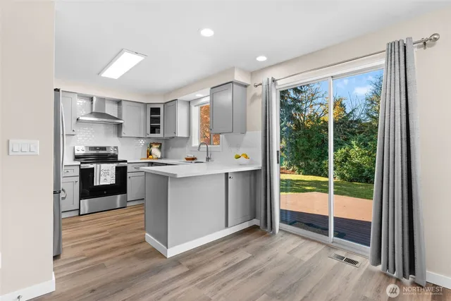 a kitchen with a refrigerator a sink and a large window