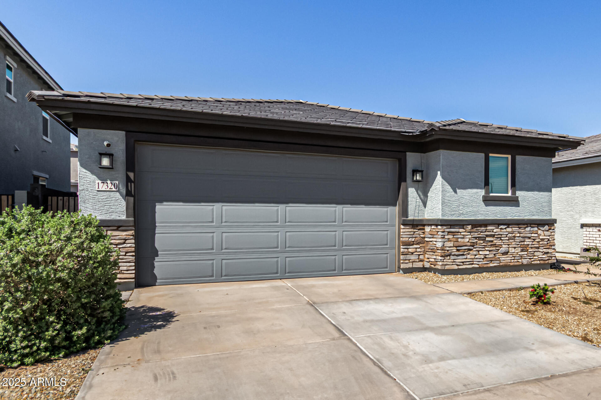 17320 West Daley Lane Surprise, AZ 85387 - Photo 11 of 46 a front view of a house with a garage