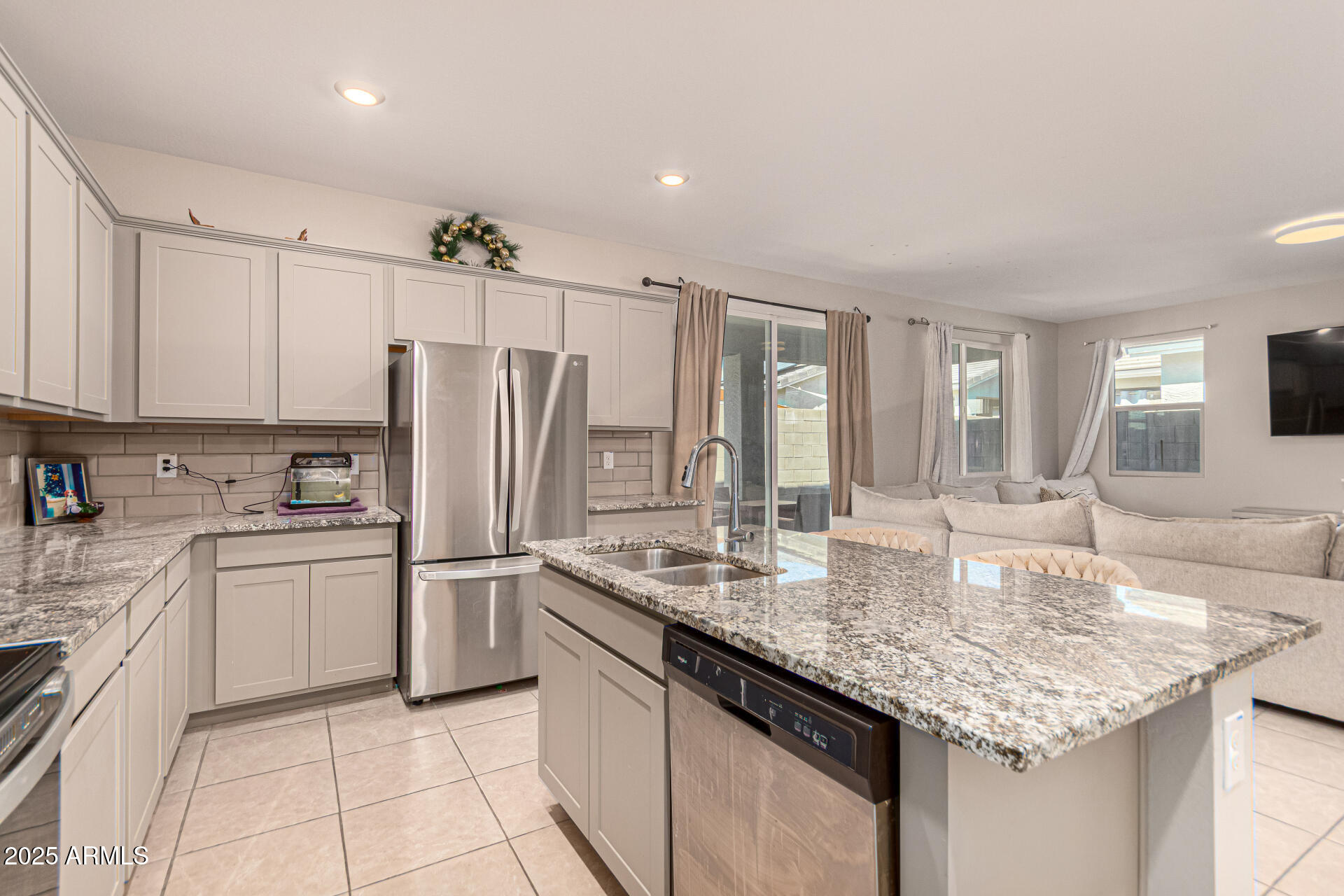 17320 West Daley Lane Surprise, AZ 85387 - Photo 16 of 46 a kitchen with stainless steel appliances granite countertop a sink refrigerator and cabinets
