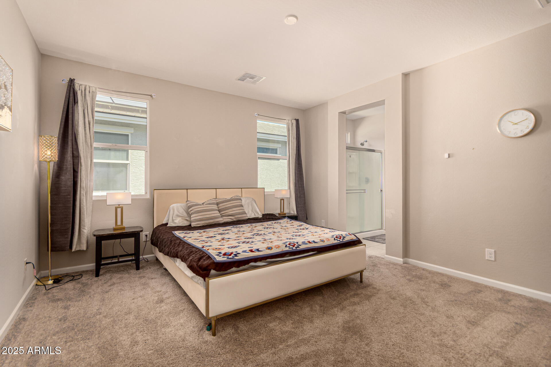 17320 West Daley Lane Surprise, AZ 85387 - Photo 18 of 46 a bedroom with a bed and window