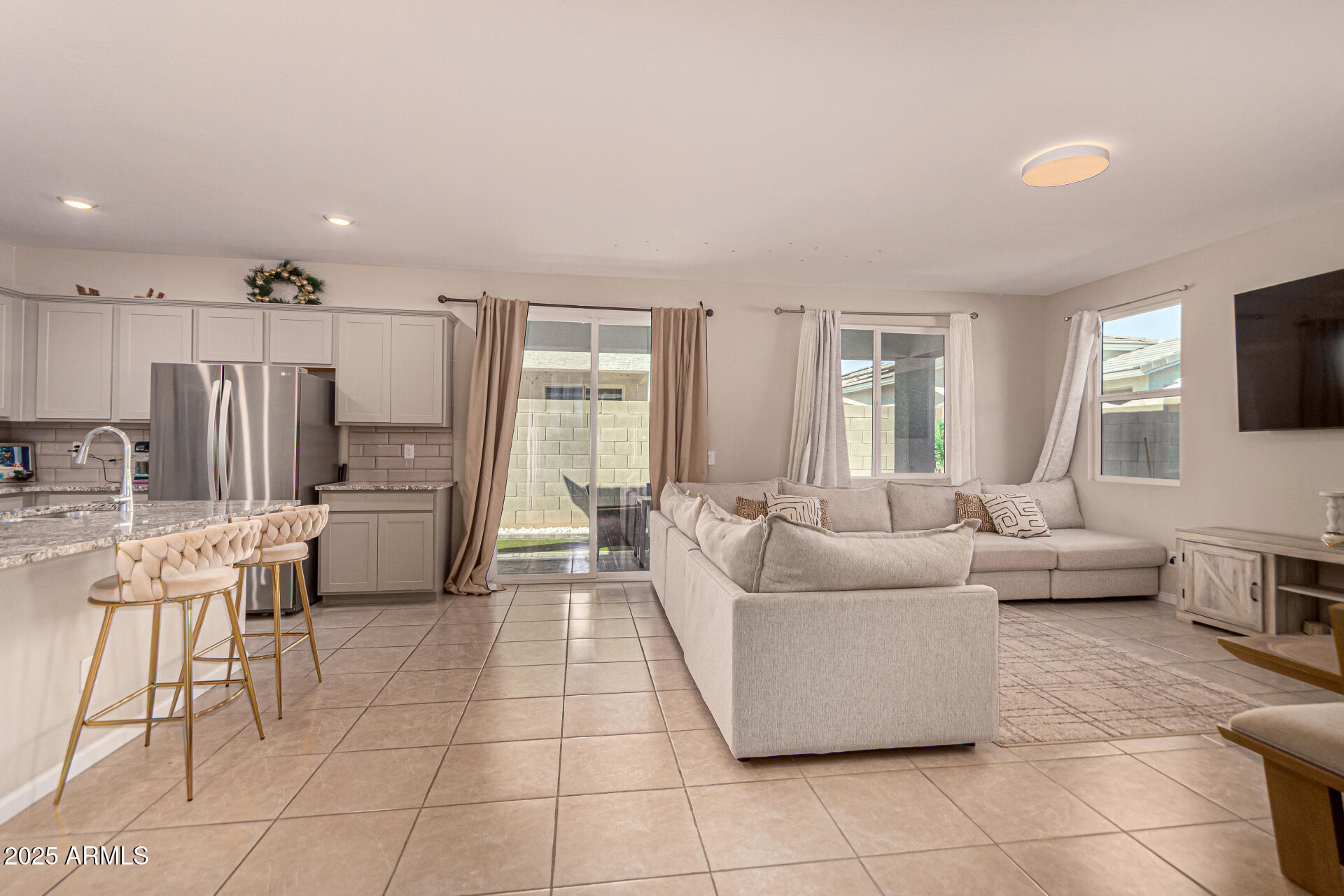 17320 West Daley Lane Surprise, AZ 85387 - Photo 2 of 46 a living room with furniture and a flat screen tv