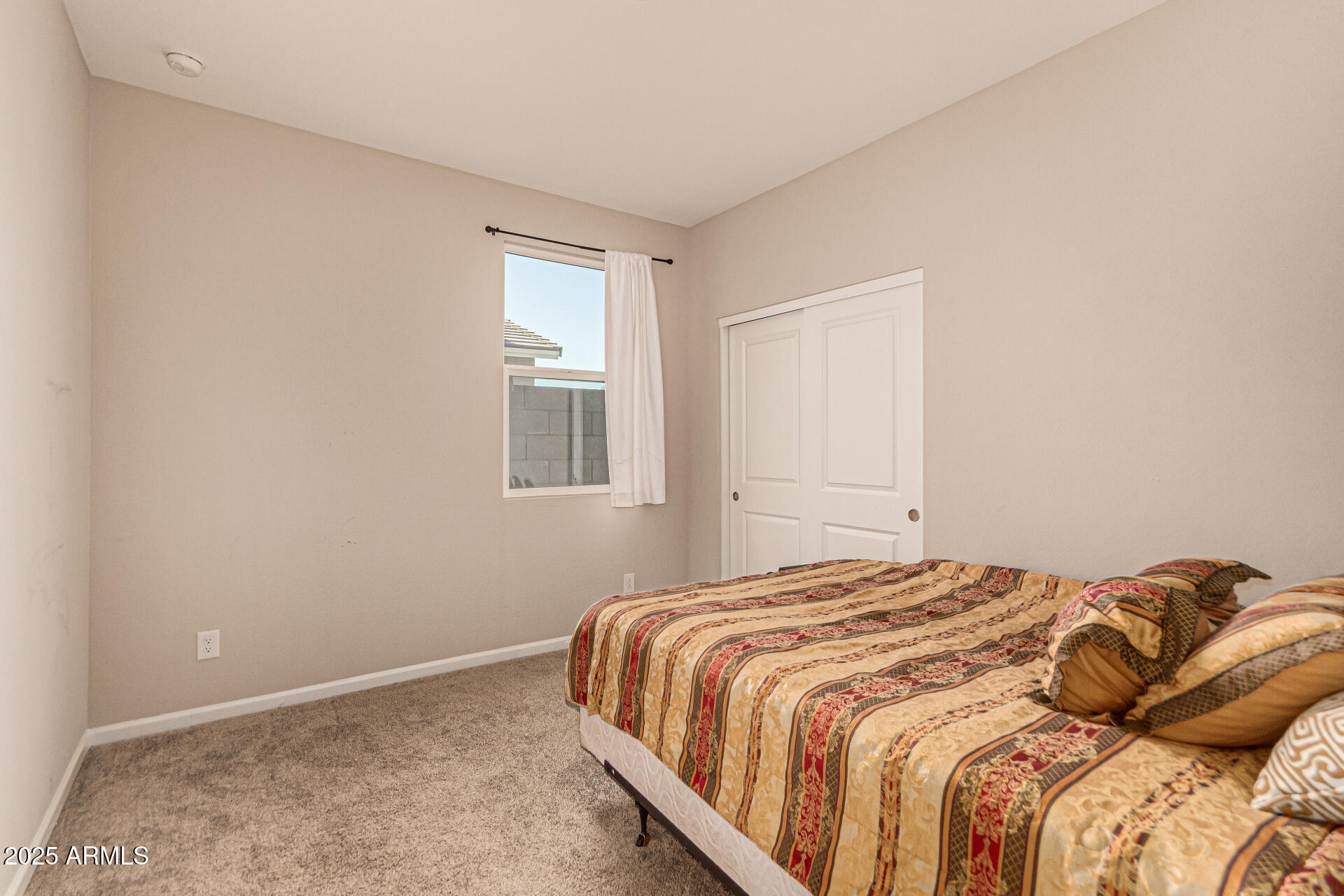 17320 West Daley Lane Surprise, AZ 85387 - Photo 23 of 46 a bedroom with a bed and a window