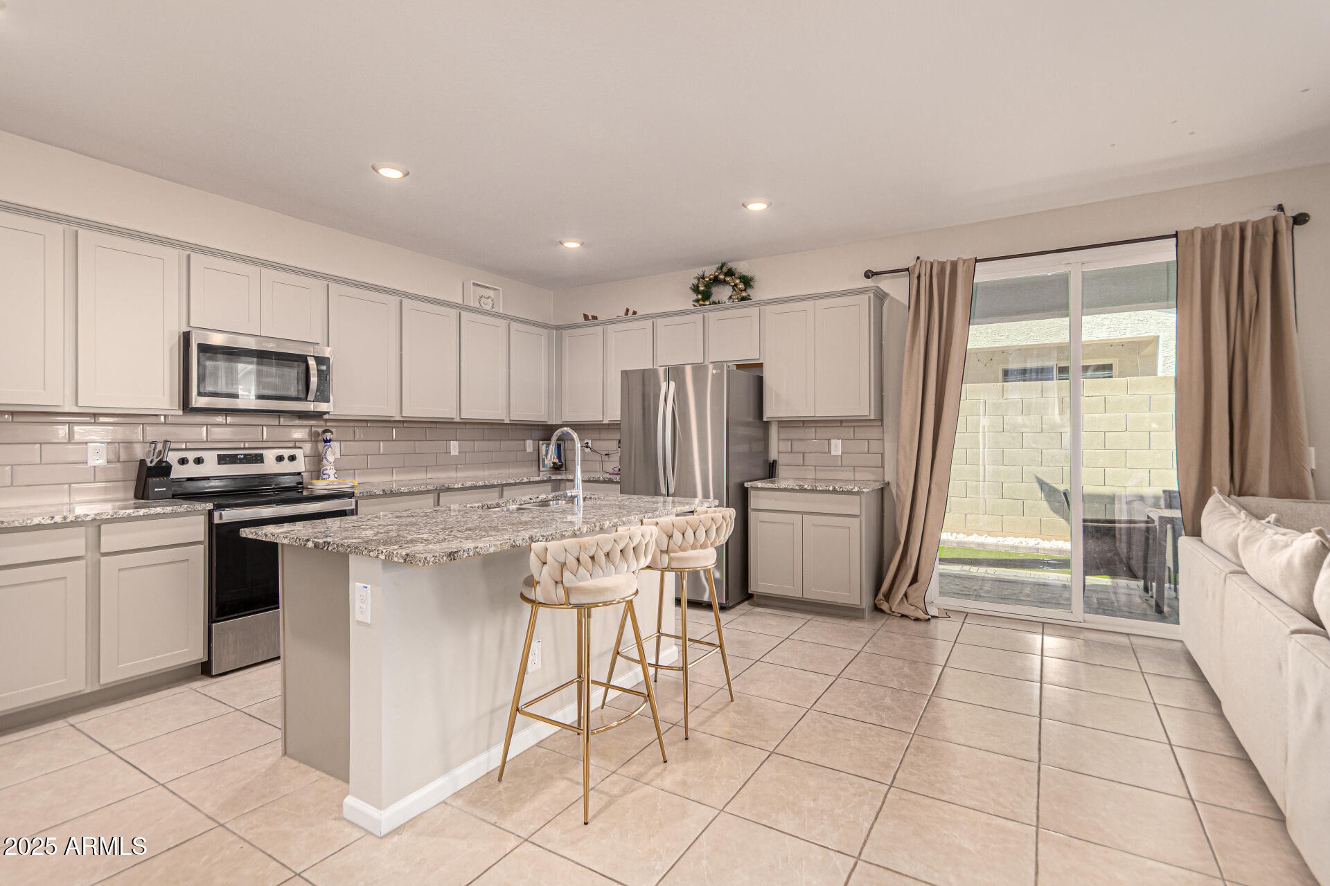 17320 West Daley Lane Surprise, AZ 85387 - Photo 4 of 46 a kitchen with a sink a counter top space appliances and cabinets