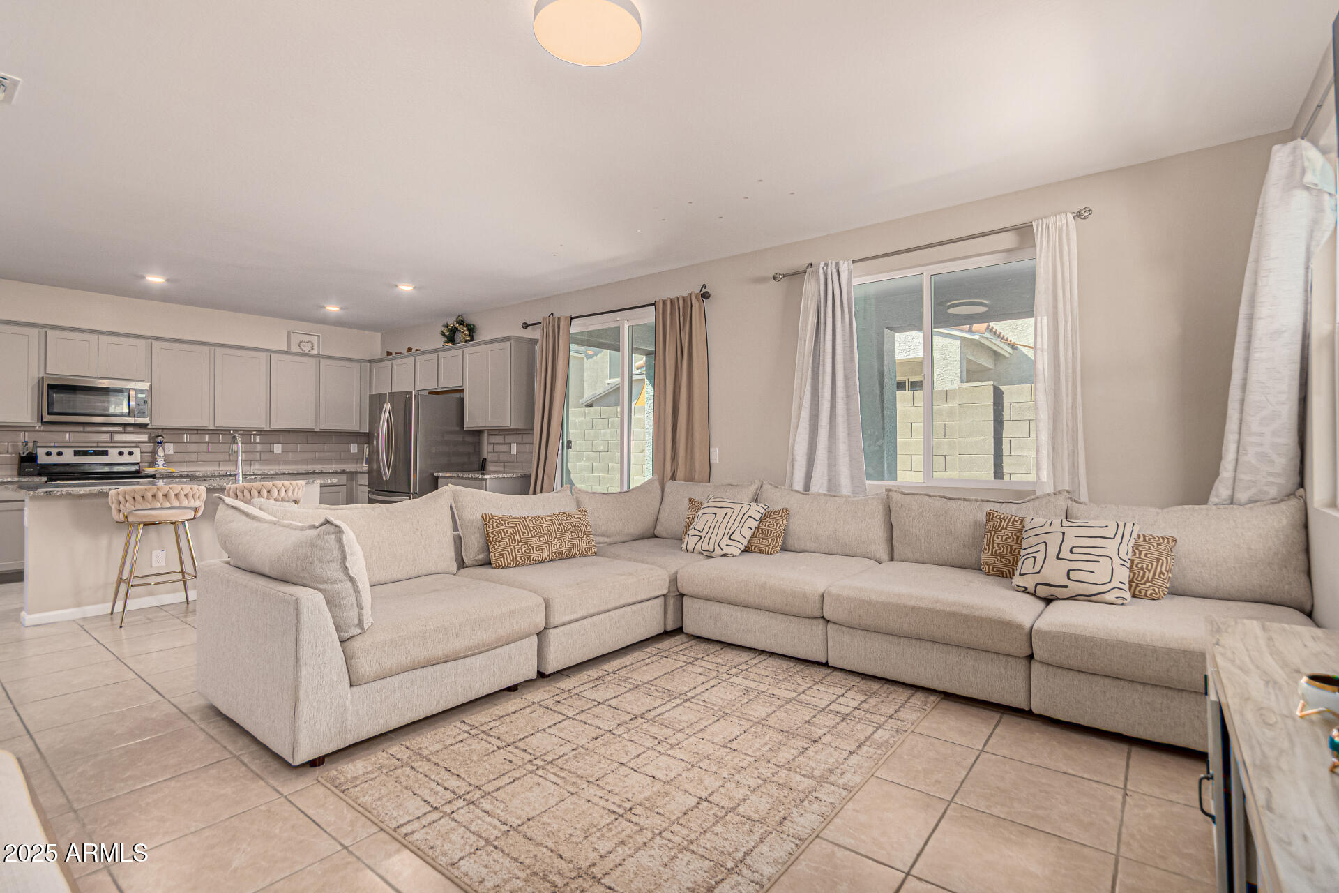 17320 West Daley Lane Surprise, AZ 85387 - Photo 5 of 46 a living room with furniture and a large window