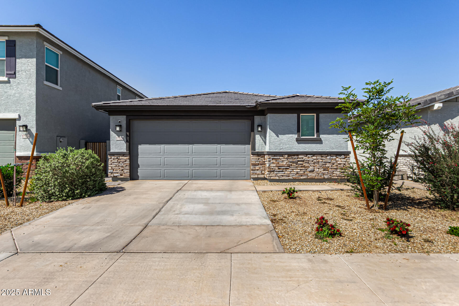 17320 West Daley Lane Surprise, AZ 85387 - Photo 9 of 46 a front view of a house with a yard