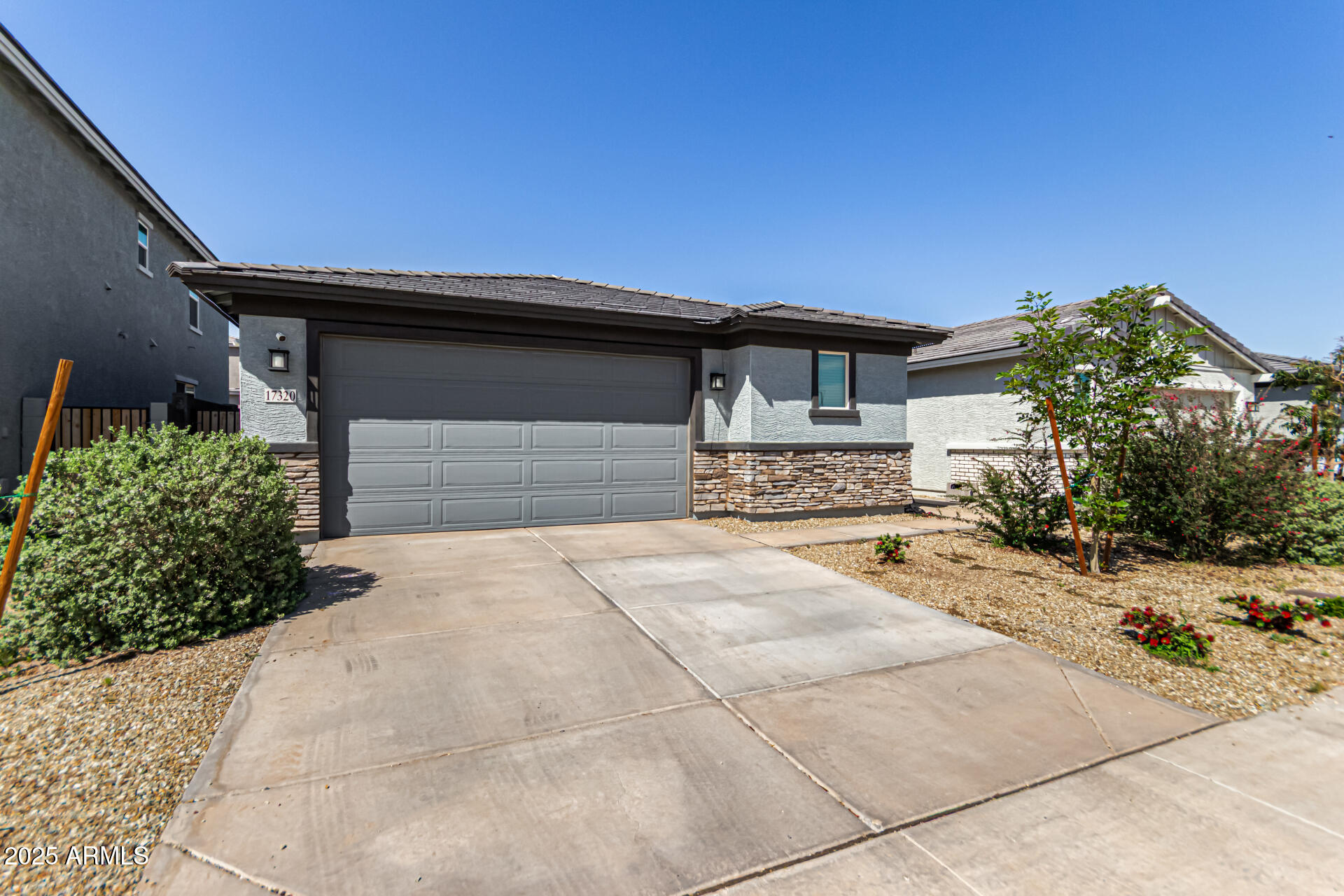 17320 West Daley Lane Surprise, AZ 85387 - Photo 10 of 46 a front view of a house with a yard