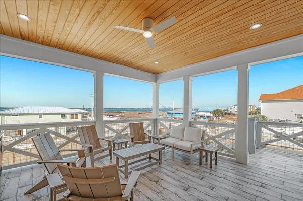 a bedroom with furniture and a large window
