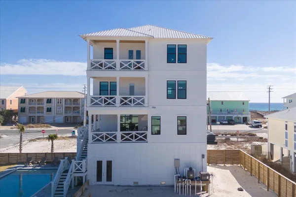 a view of a patio with table and chairs with wooden floor and fence