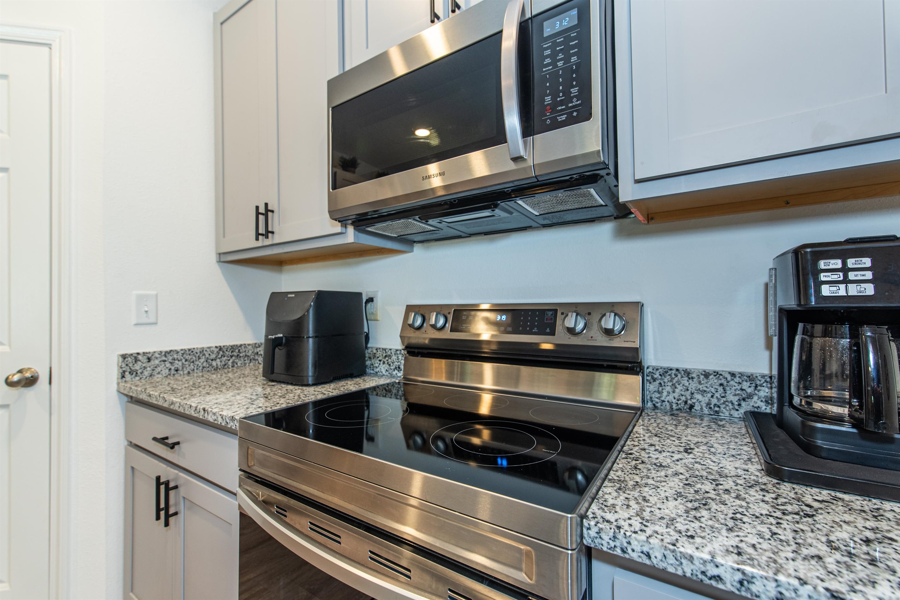 18 Ridge Lake Road St. Augustine, FL 32086 - Photo 11 of 47 a kitchen with stainless steel appliances granite countertop a stove and a microwave