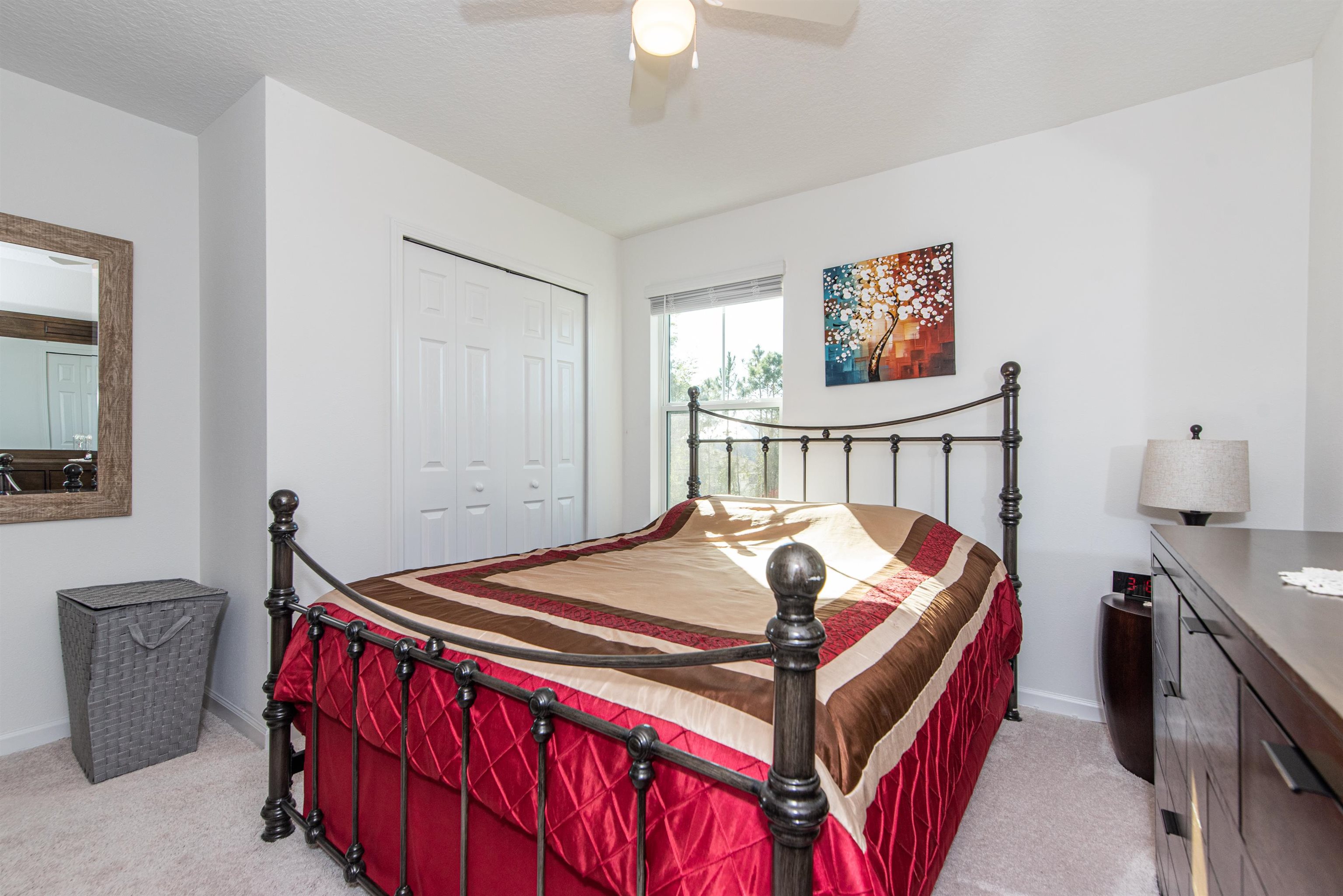 18 Ridge Lake Road St. Augustine, FL 32086 - Photo 34 of 47 a bedroom with a bed and a chandelier