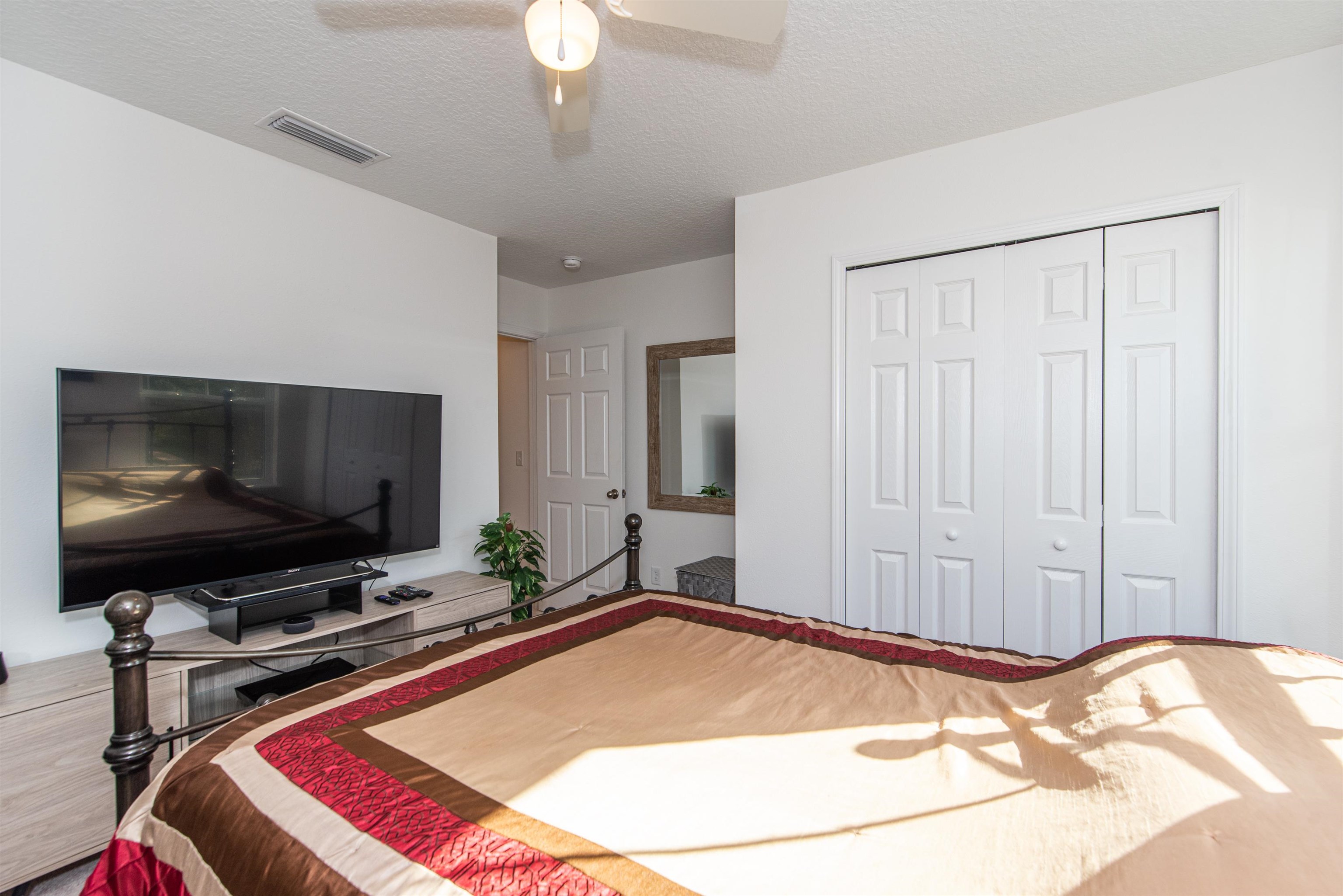 18 Ridge Lake Road St. Augustine, FL 32086 - Photo 35 of 47 a bedroom with a bed and a flat screen tv