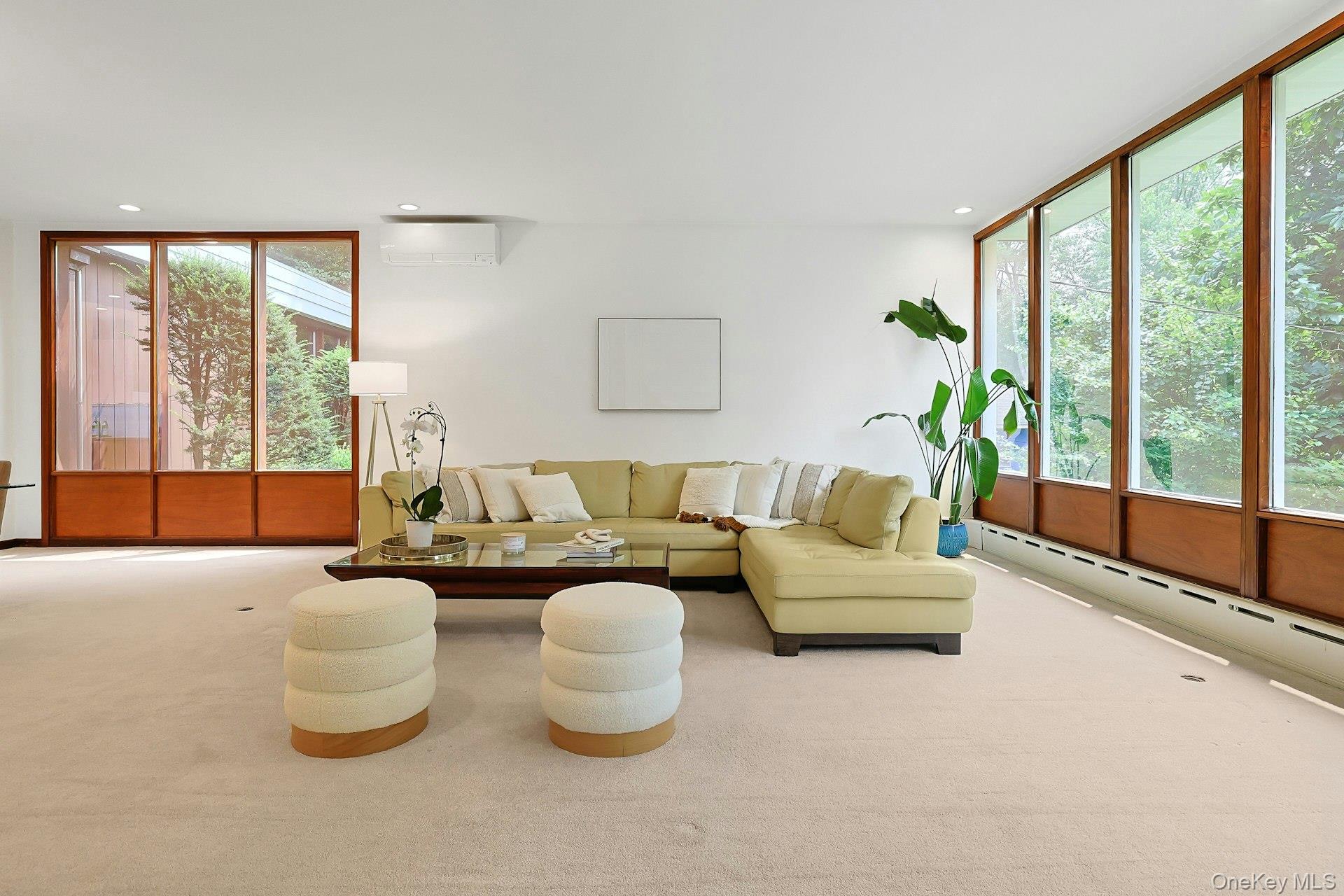 20 Sprain Valley Road Scarsdale, NY 10583 - Photo 8 of 30 A warm and inviting gathering space with iconic Mid-Century Modern styling, offering panoramic wooded views and an effortless flow for everyday living and entertaining.