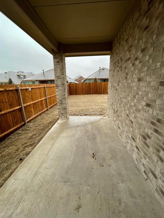 3700 Milkweed Road McKinney, TX 75071 - Photo 14 of 18 Covered concrete patio featuring a brick column and exterior wall