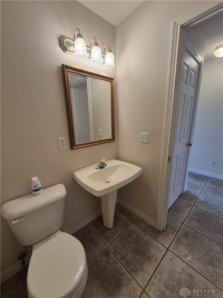 633 Orient Way Hamilton, OH 45013 - Photo 30 of 68 This bathroom features a contemporary pedestal sink and durable tile flooring.
