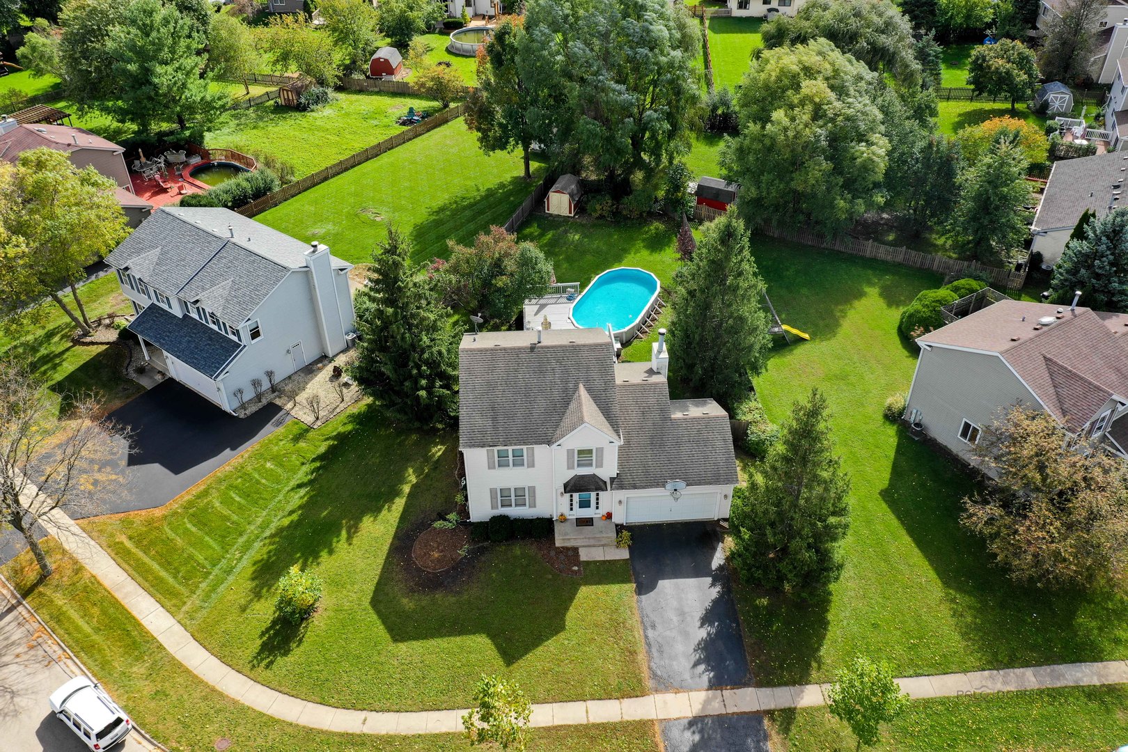an aerial view of a house with a garden and swimming pool