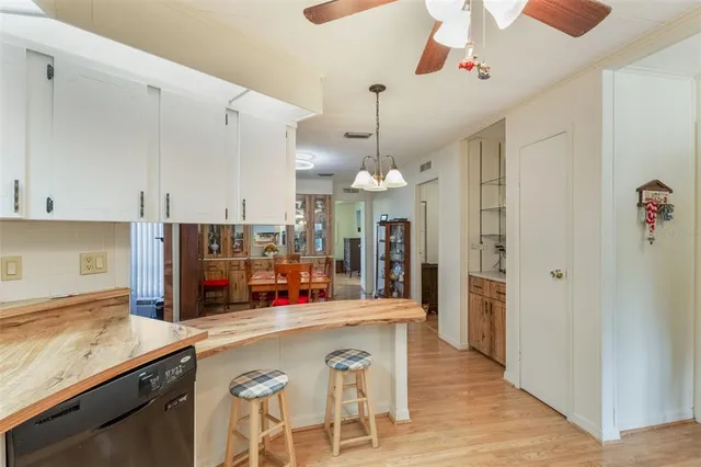 a kitchen with stainless steel appliances kitchen island granite countertop a refrigerator and microwave