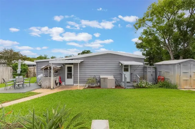 a front view of house with yard and outdoor seating