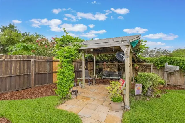 a view of a chair and table in backyard of the house