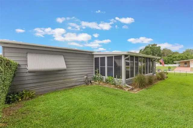a view of house with backyard