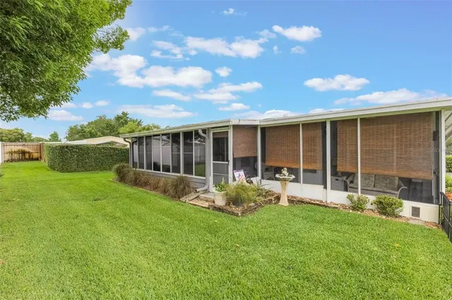 a view of a house with backyard sitting area and garden