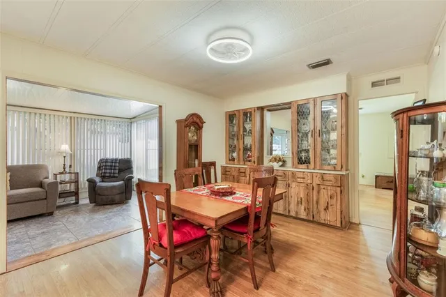 a dining room with furniture and wooden floor