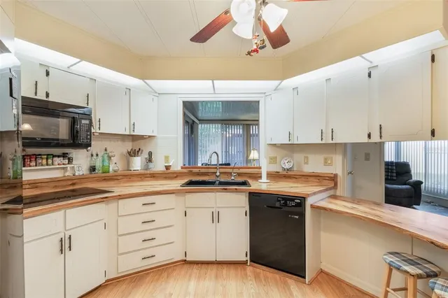 a kitchen with stainless steel appliances granite countertop a sink a stove and cabinets