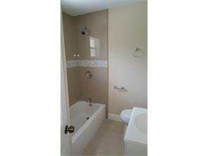 2180 Northwest 3rd Street Pompano Beach, FL 33069 - Photo 2 of 6 a bathroom with a tub shower sink and mirror