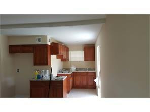 2180 Northwest 3rd Street Pompano Beach, FL 33069 - Photo 4 of 6 a kitchen with stainless steel appliances a sink stove and cabinets
