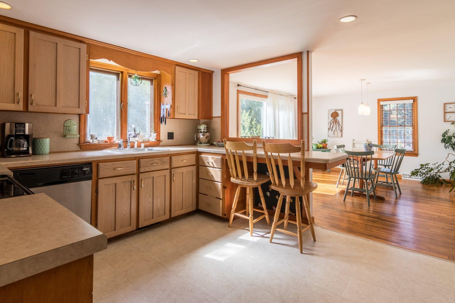 247 Chatham Road Harwich, MA 02645 - Photo 12 of 33 a large kitchen with lots of counter top space and dining table