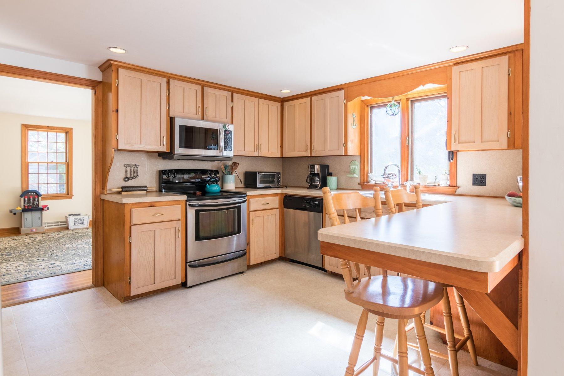 247 Chatham Road Harwich, MA 02645 - Photo 14 of 33 a kitchen with a stove a sink and a refrigerator