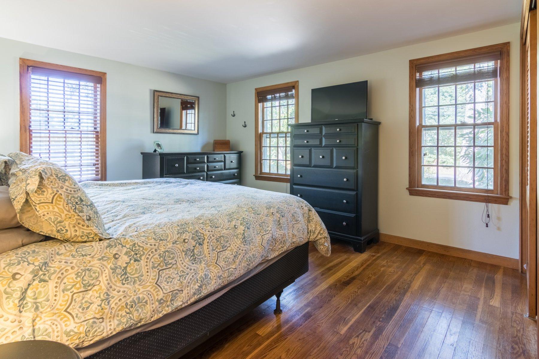 247 Chatham Road Harwich, MA 02645 - Photo 15 of 33 a bedroom with a bed and a flat screen tv