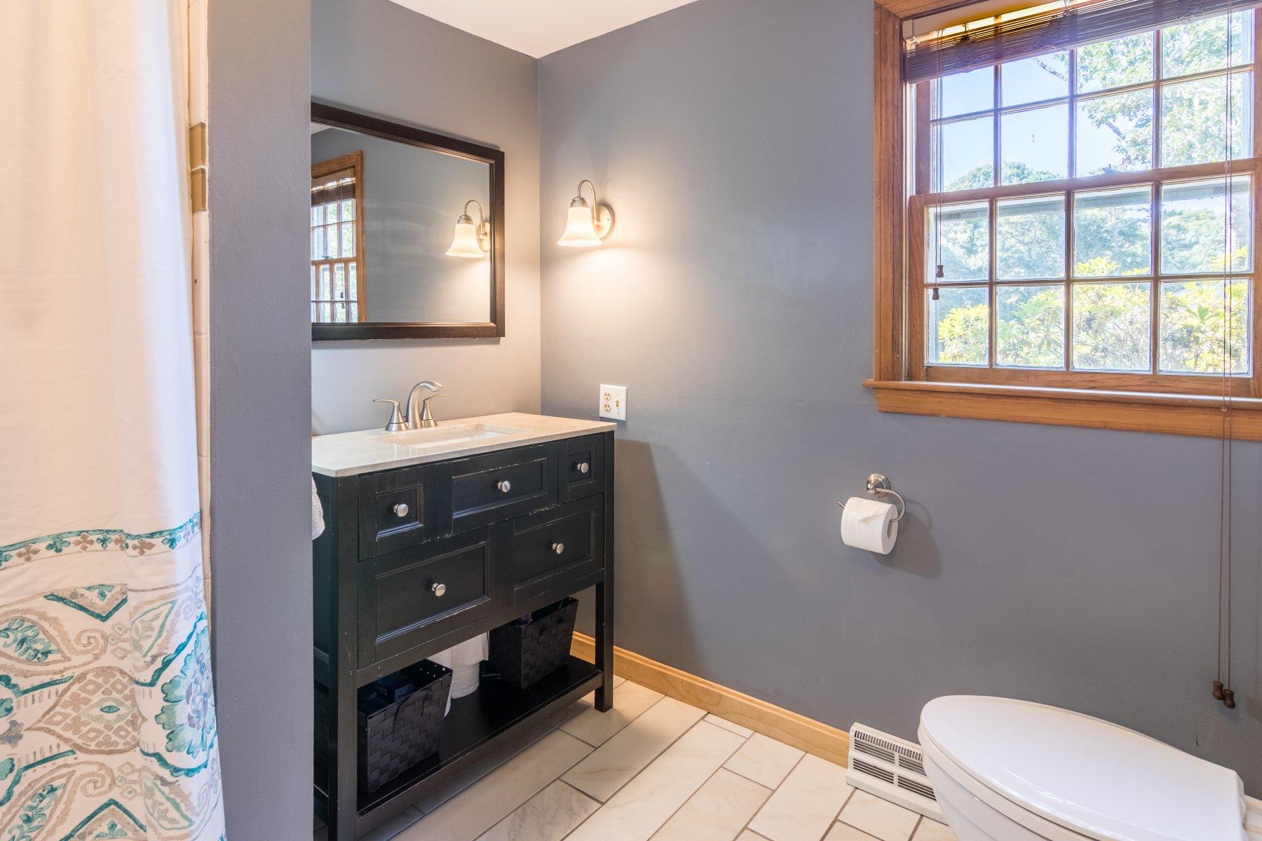 247 Chatham Road Harwich, MA 02645 - Photo 18 of 33 a bathroom with a sink mirror vanity and a toilet