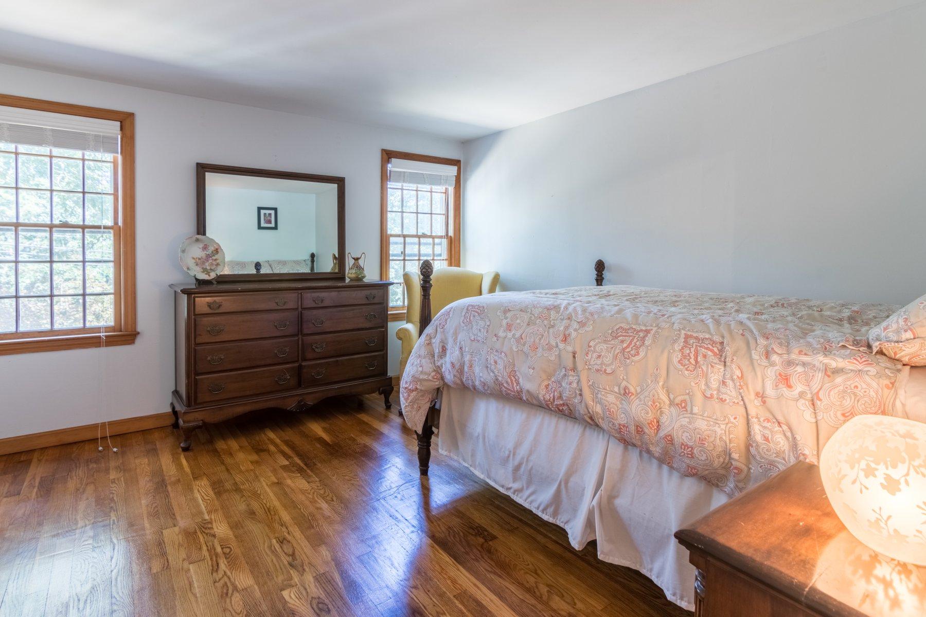 247 Chatham Road Harwich, MA 02645 - Photo 24 of 33 a bedroom with a bed and wooden floor