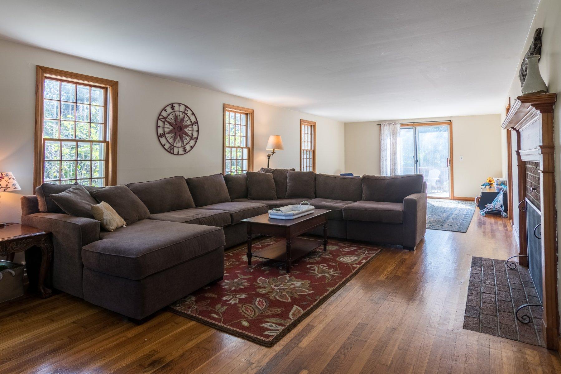 247 Chatham Road Harwich, MA 02645 - Photo 7 of 33 a living room with furniture wooden floor and a large window