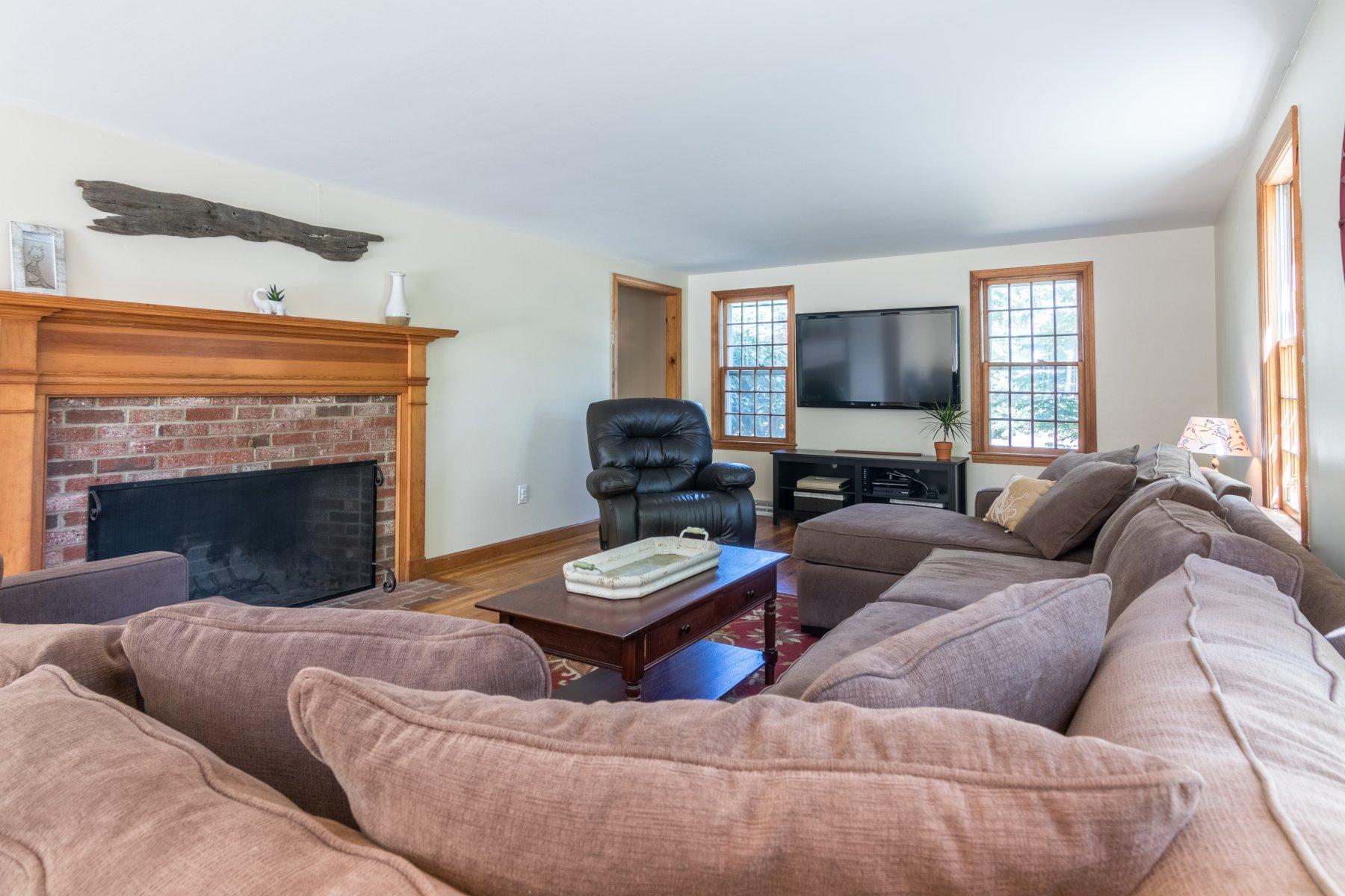247 Chatham Road Harwich, MA 02645 - Photo 8 of 33 a living room with furniture and a fireplace