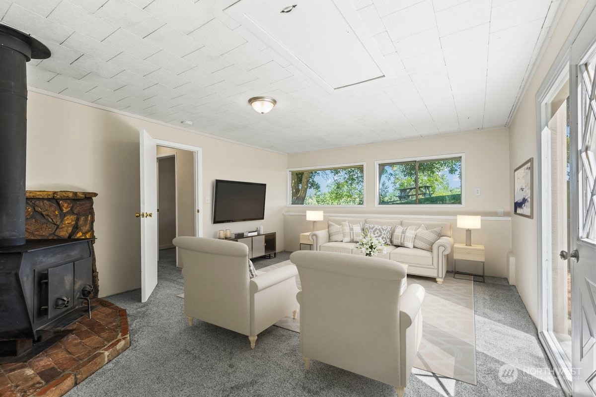 1350 Tozer Road Ellensburg, WA 98926 - Photo 22 of 40 a living room with furniture a flat screen tv and a fireplace