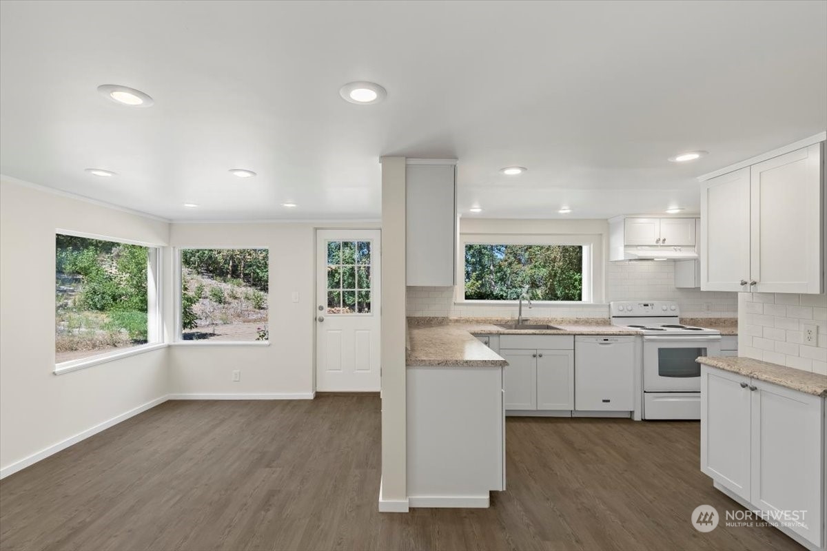 1350 Tozer Road Ellensburg, WA 98926 - Photo 6 of 40 a kitchen with white cabinets and white appliances