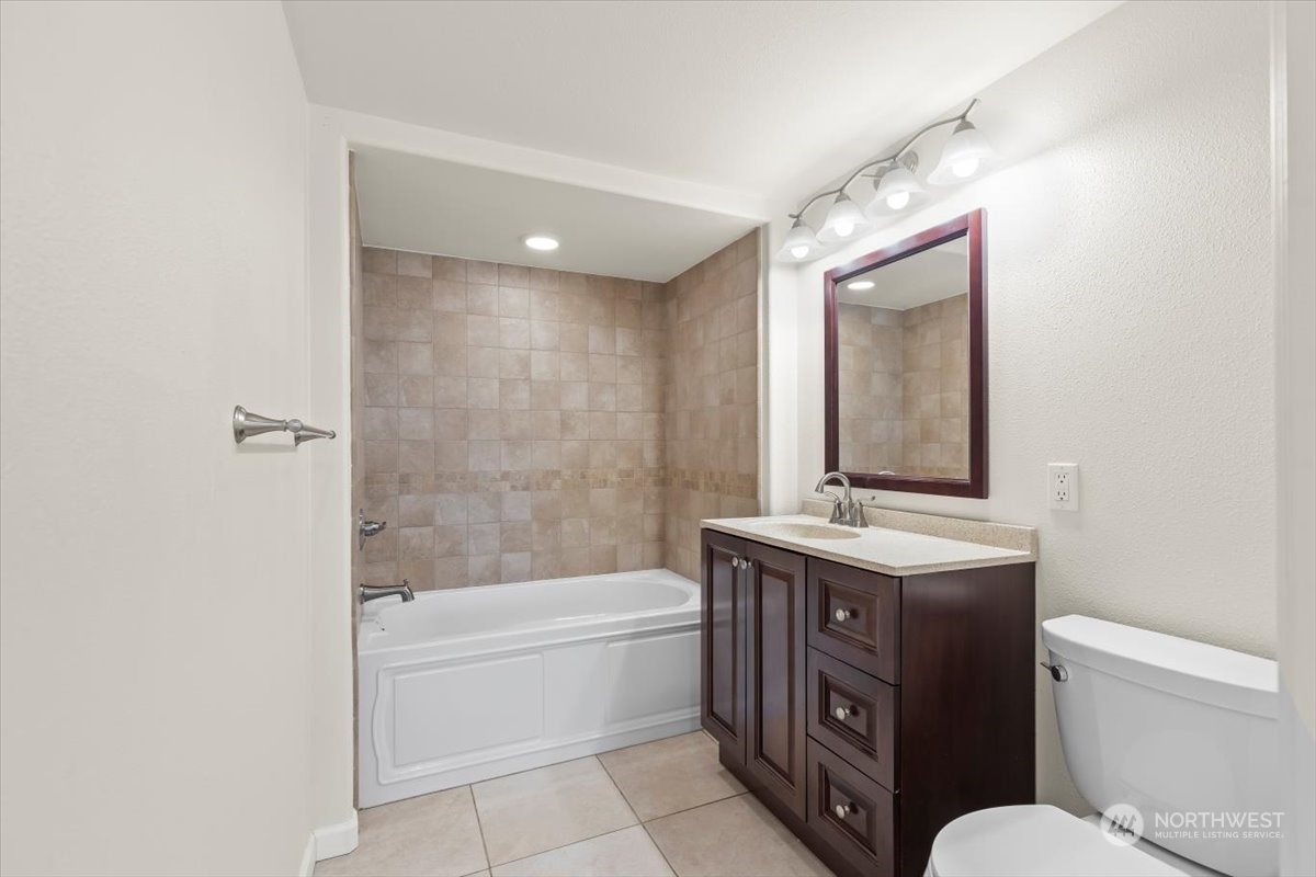 1350 Tozer Road Ellensburg, WA 98926 - Photo 10 of 40 a bathroom with a granite countertop sink mirror bathtub and toilet