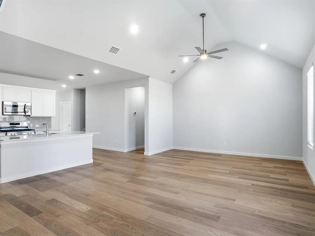 641 Poppy Lane Lavon, TX 75166 - Photo 4 of 12 Unfurnished living room featuring ceiling fan, recessed lighting, and light wood finished floors