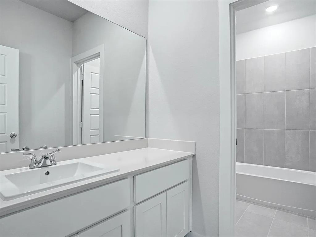 641 Poppy Lane Lavon, TX 75166 - Photo 7 of 12 Bathroom with vanity, bathing tub / shower combination, and light tile patterned flooring