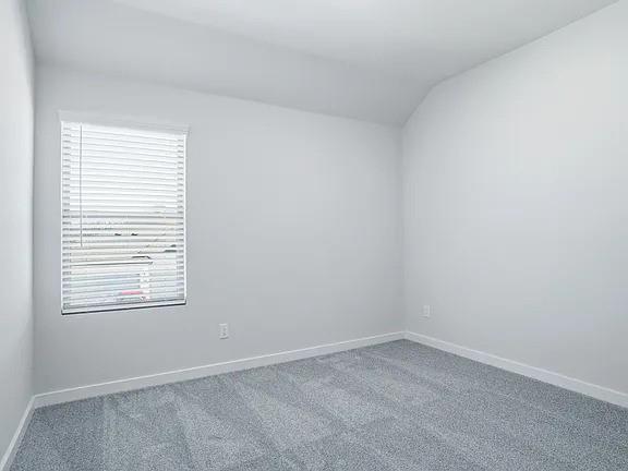 641 Poppy Lane Lavon, TX 75166 - Photo 8 of 12 Carpeted empty room featuring lofted ceiling and baseboards
