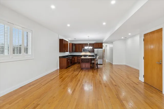 a big room with wooden floor and furniture