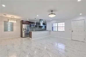 a kitchen with stainless steel appliances a refrigerator and a sink