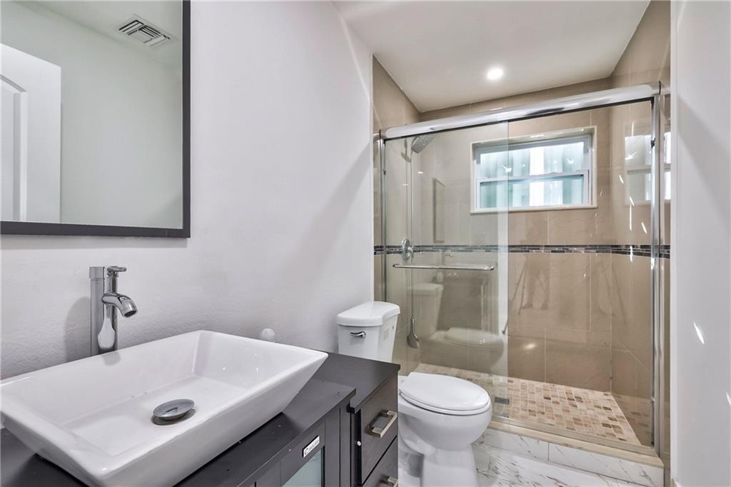 1389 West 33rd Street Riviera Beach, FL 33404 - Photo 15 of 20 a bathroom with a sink toilet and shower