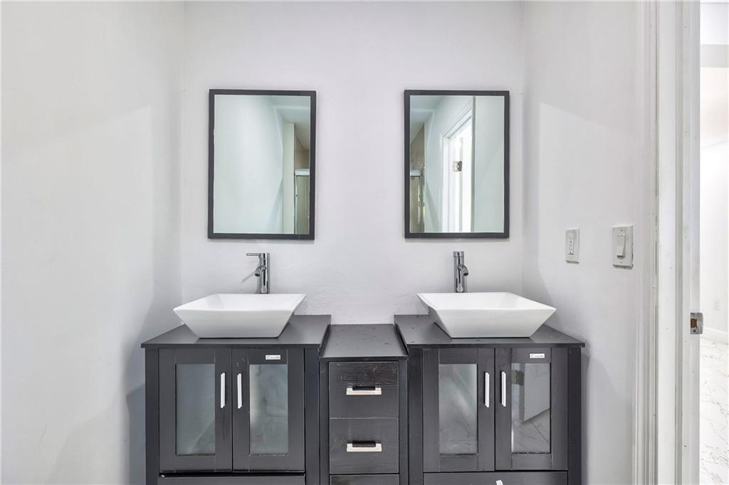 1389 West 33rd Street Riviera Beach, FL 33404 - Photo 16 of 20 a bathroom with a sink and a mirror