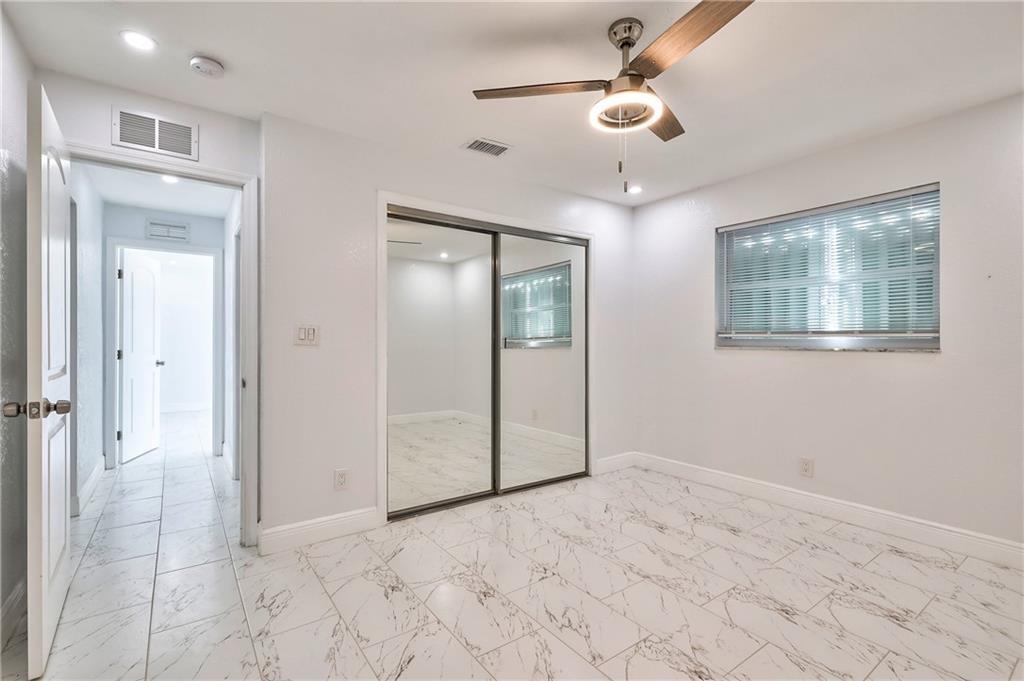 1389 West 33rd Street Riviera Beach, FL 33404 - Photo 17 of 20 an empty room with fan and windows