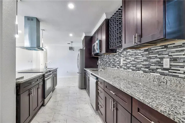 a kitchen with stainless steel appliances granite countertop a granite counter tops and wooden cabinets