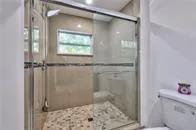 a bathroom with a window and a shower