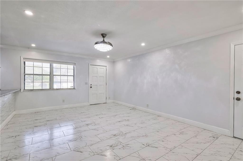 1389 West 33rd Street Riviera Beach, FL 33404 - Photo 8 of 20 an empty room with windows and fan