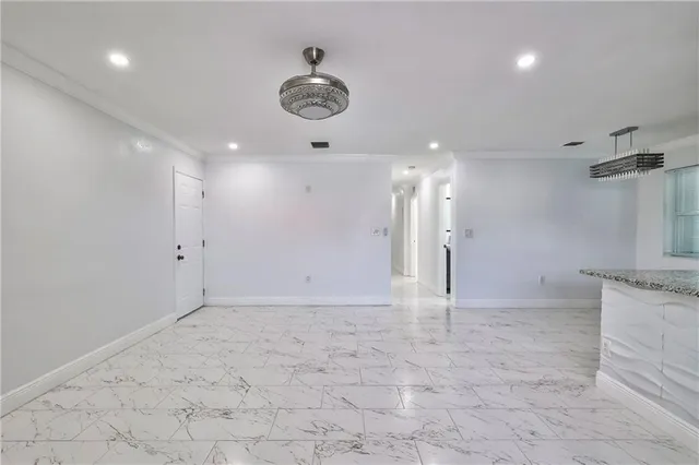 a view of a kitchen with a sink and a refrigerator
